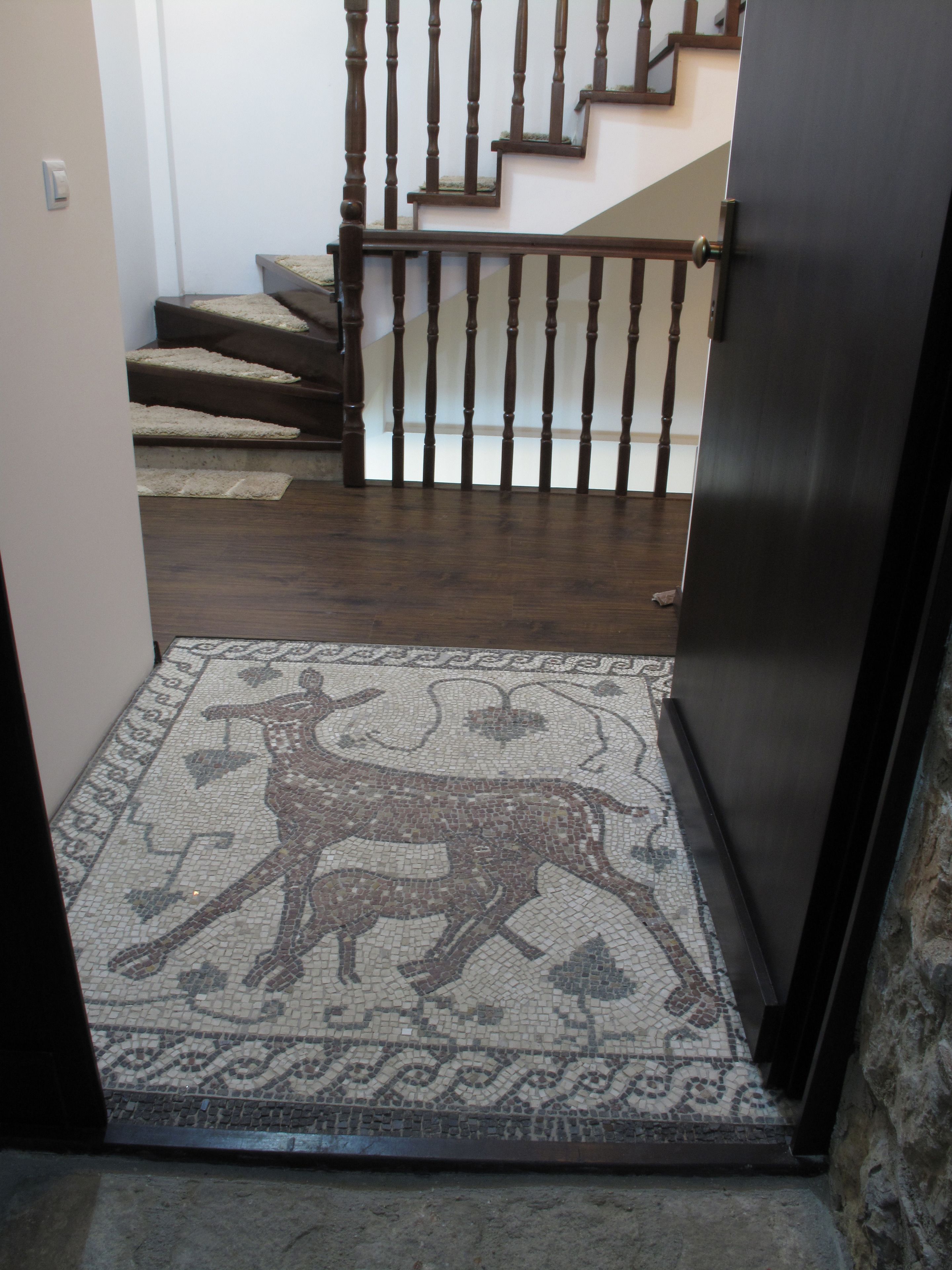 A staircase with wooden balusters and a carpeted landing.