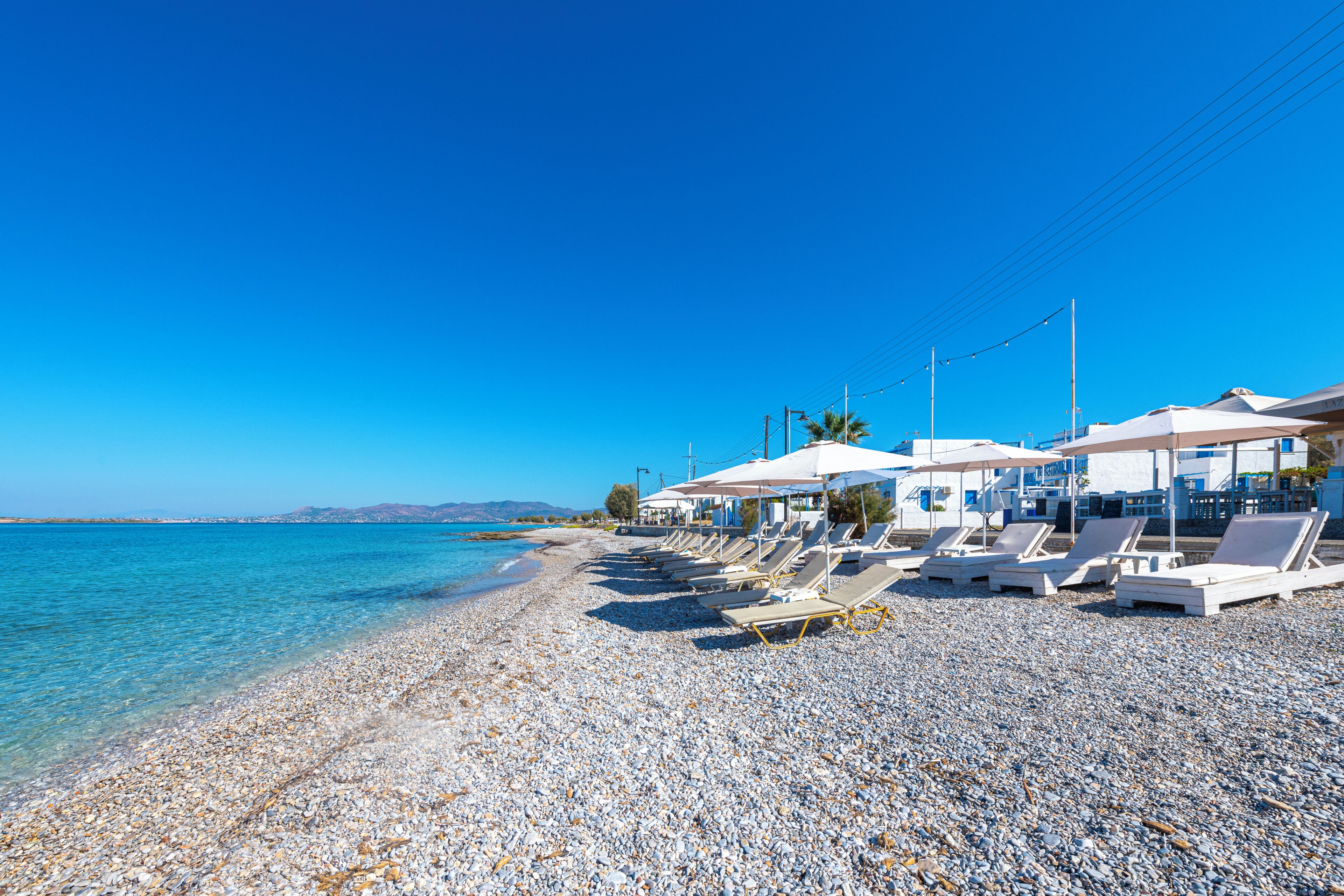 On the beach, sun-loungers, beach umbrellas, beach bar