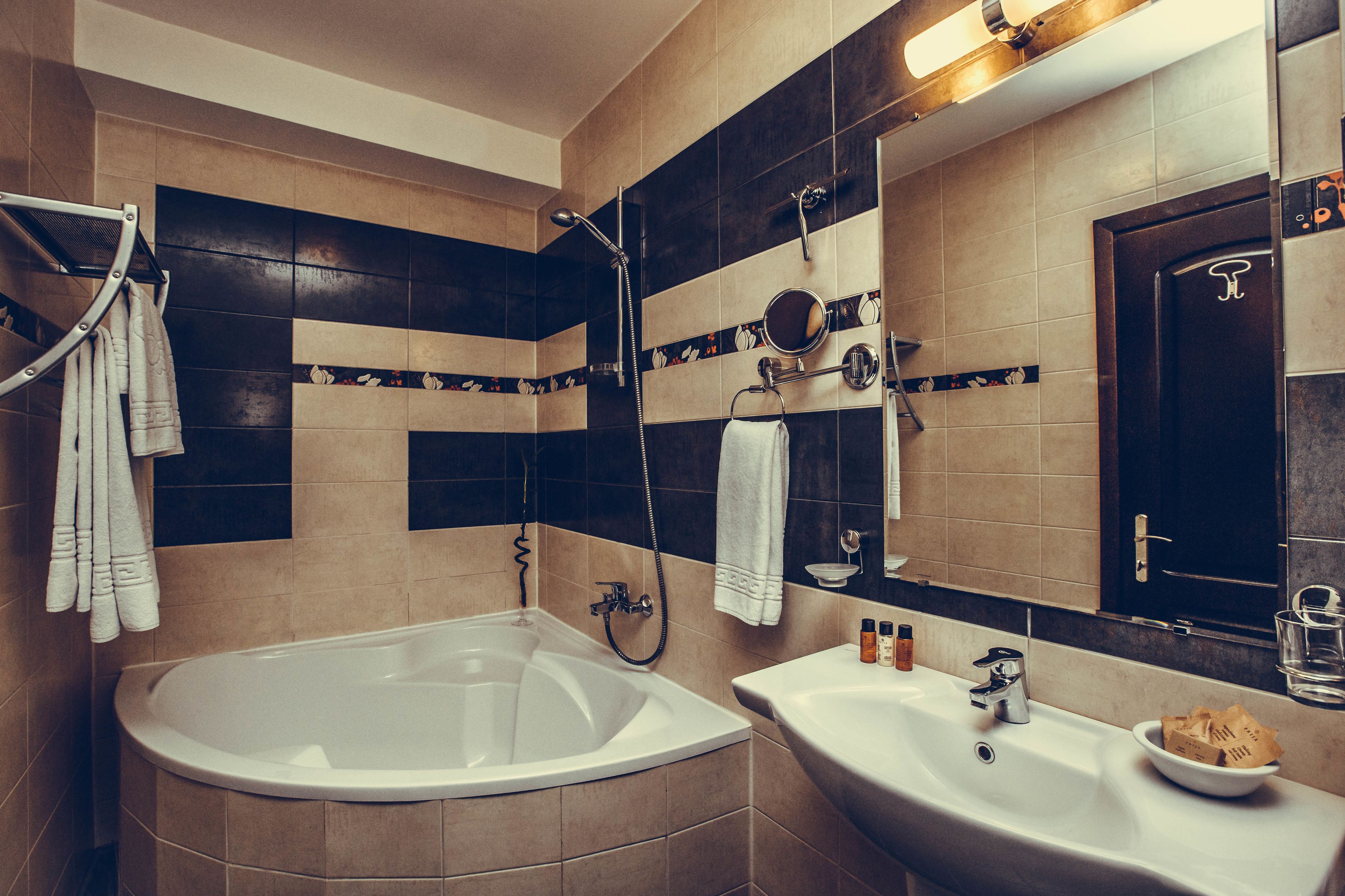 premium suite | bathroom | combined shower/bathtub, designer toiletries, hair dryer, bathrobes