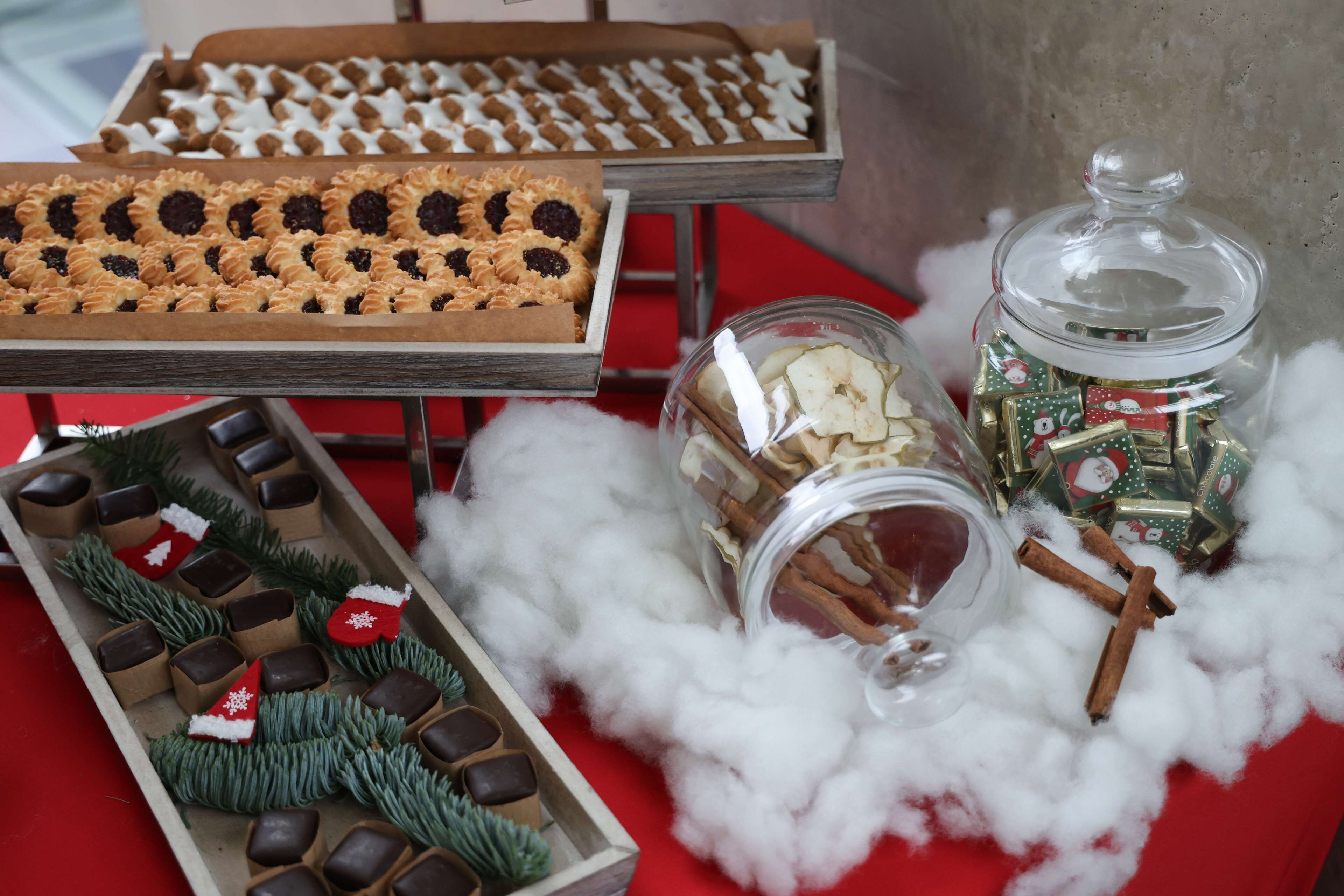 A variety of desserts on display, including cookies and pastries, arranged on trays.