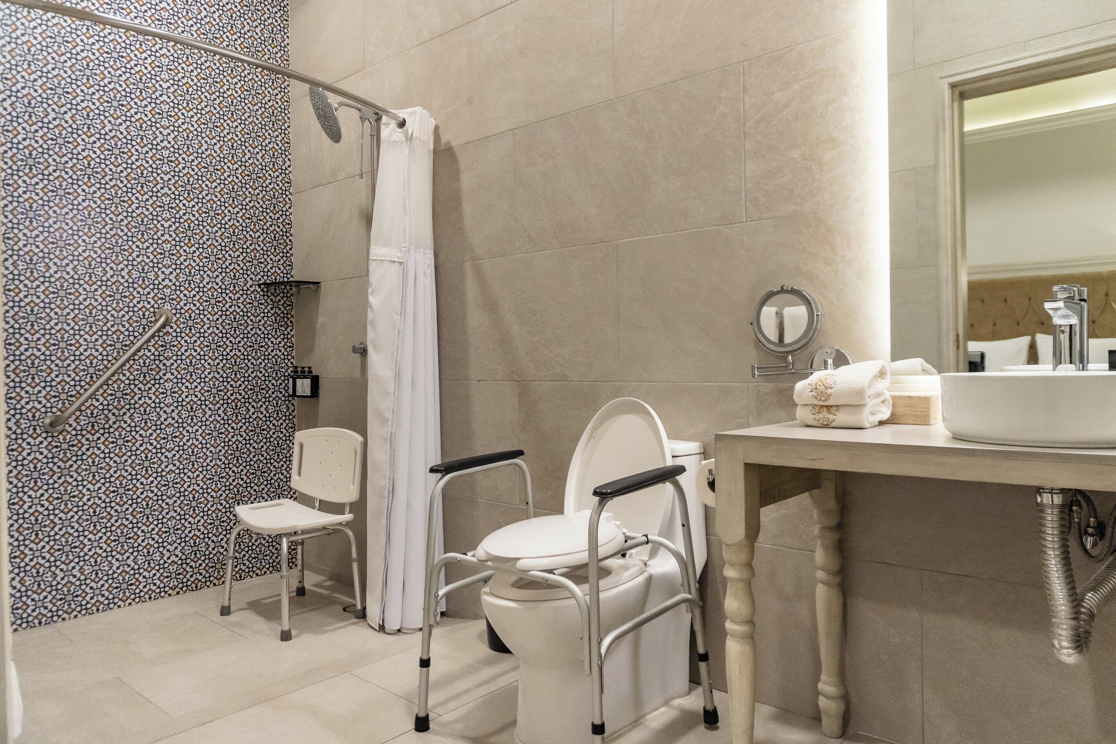 A bathroom with a shower, toilet, and sink.