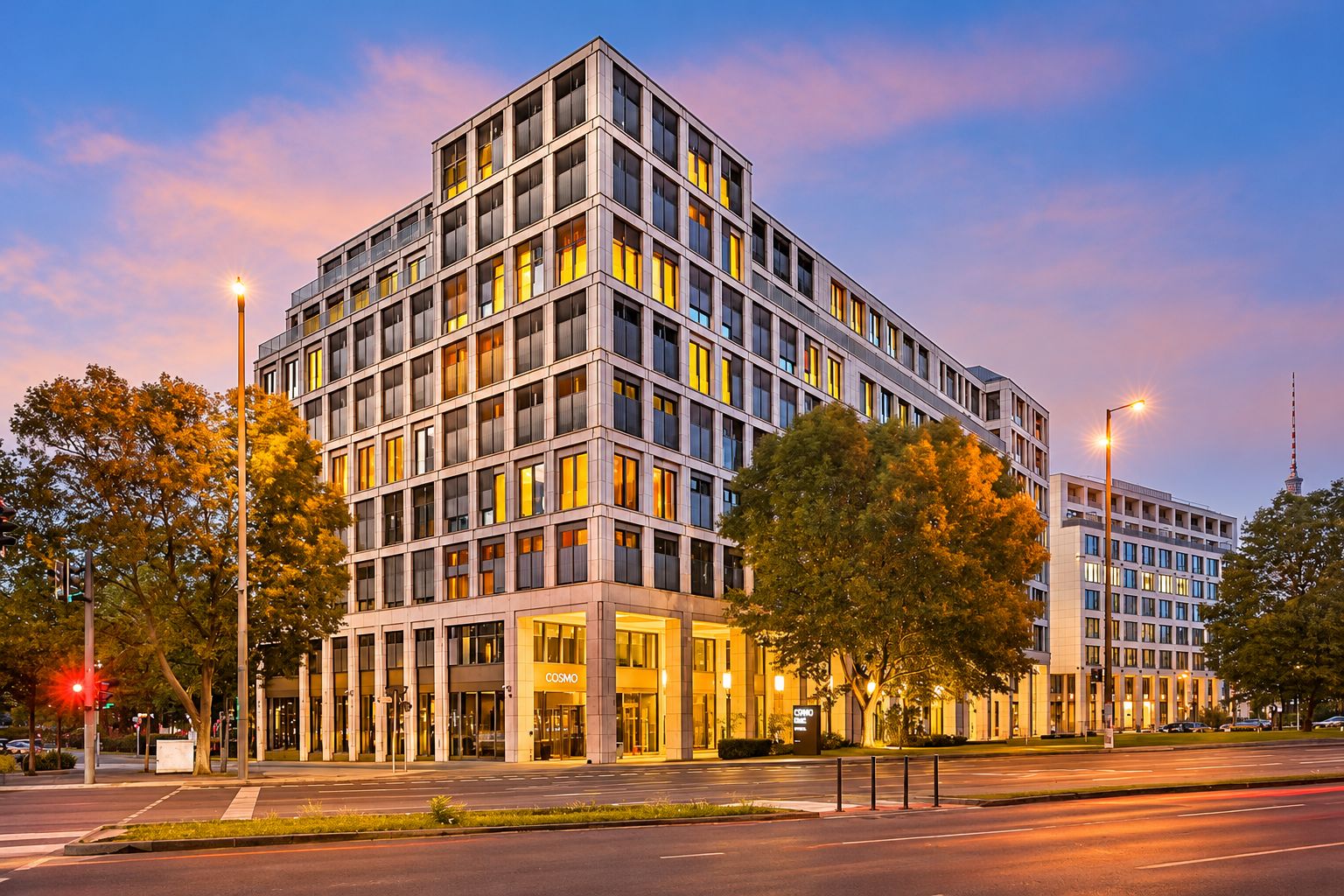 A modern multi-story building with a prominent entrance and a visible sign reading 'COSMO'.