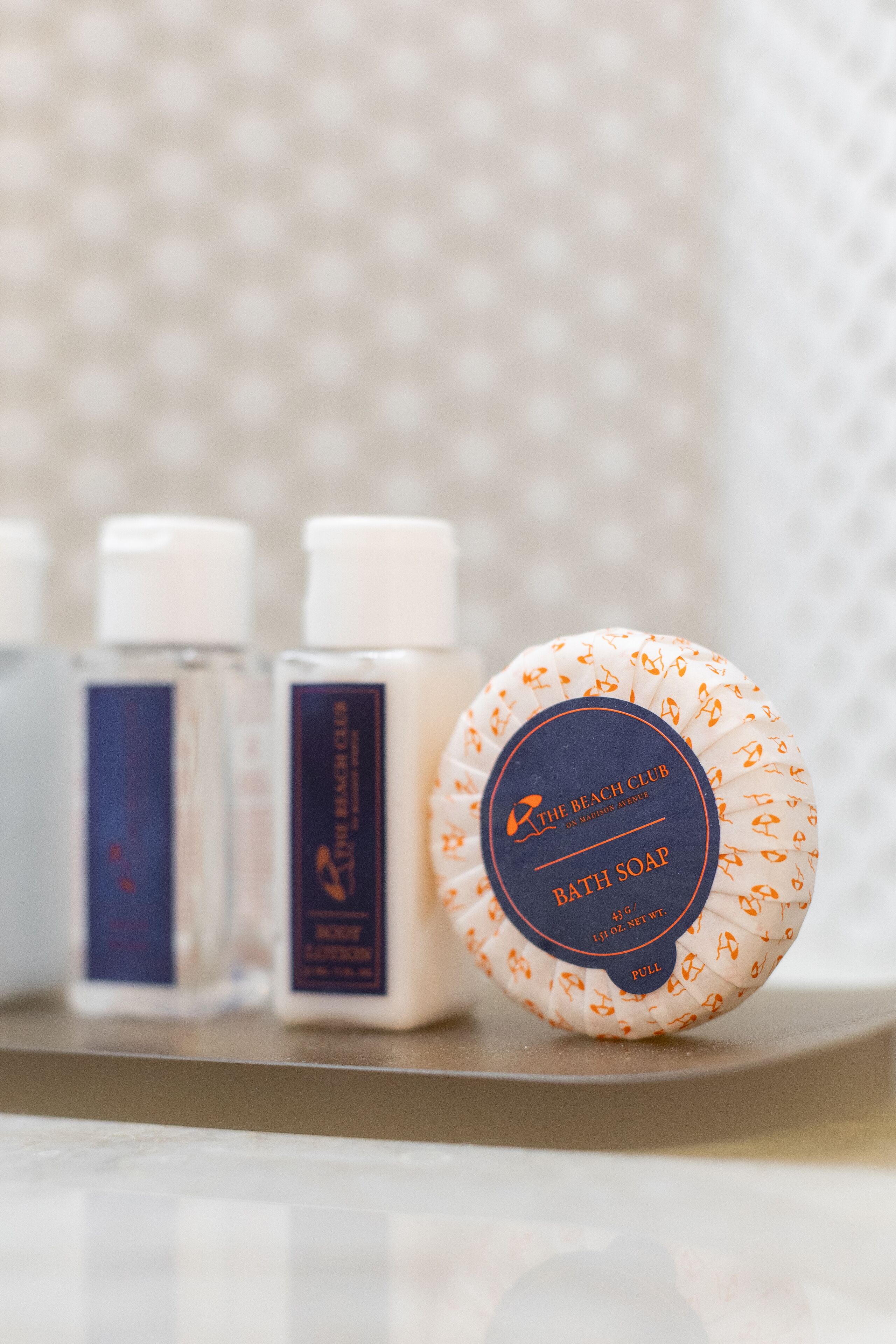 A set of toiletries including bath soap and body lotion on a tray.