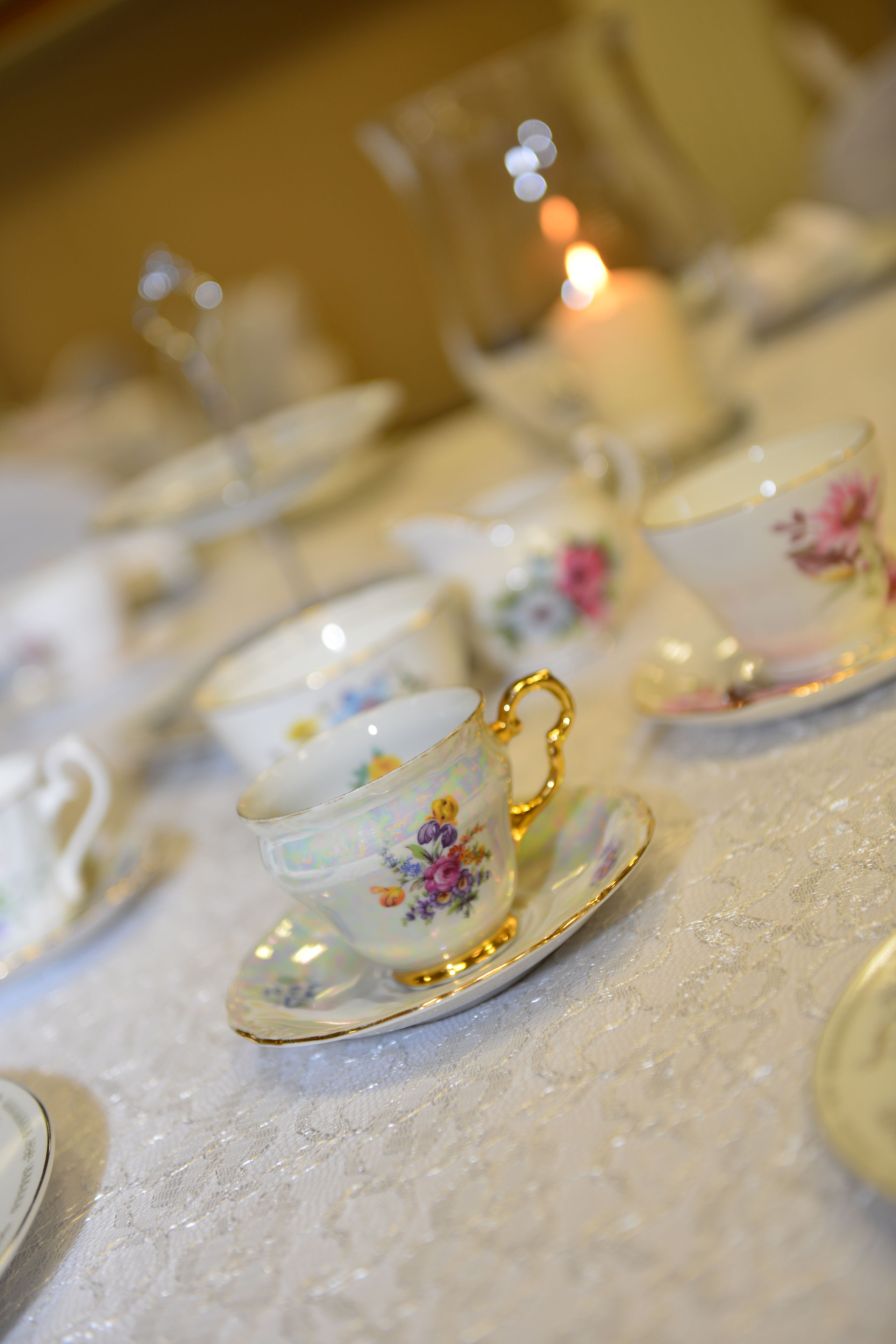 A table set with floral-patterned tea cups and saucers.