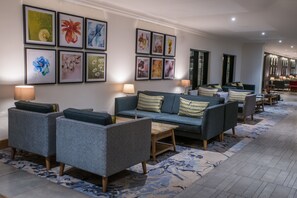 Relax in this stylish living area with a sofa, coffee table, and framed artworks.