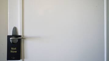 A door with a "Not Now" sign on a black plate.