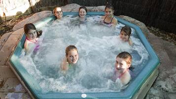 A hot tub with six people in it.