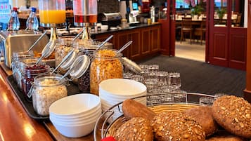 A buffet setup with various food items and beverages.