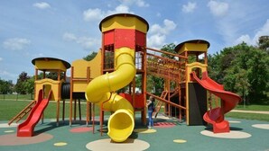 Ein Spielplatz mit mehreren Rutschen und Klettergerüsten.