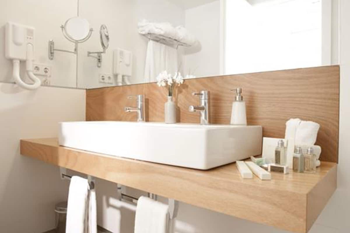 designer toiletries, hair dryer, towels