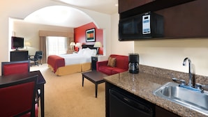 A hotel room with a bed, a desk, a chair, a coffee maker, a microwave, and a sink. - Holiday Inn Express & Suites Casa Grande by IHG (Casa Grande)