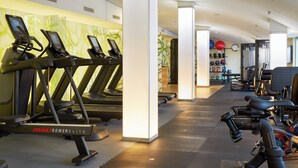 A gym with treadmills, a stationary bike, and various exercise equipment.