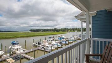 A balcony with a view of a marina and a river.