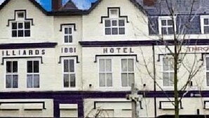 A row of buildings with signs reading "Billiards" and "Hotel." - Throstles Nest Hotel (Liverpool)