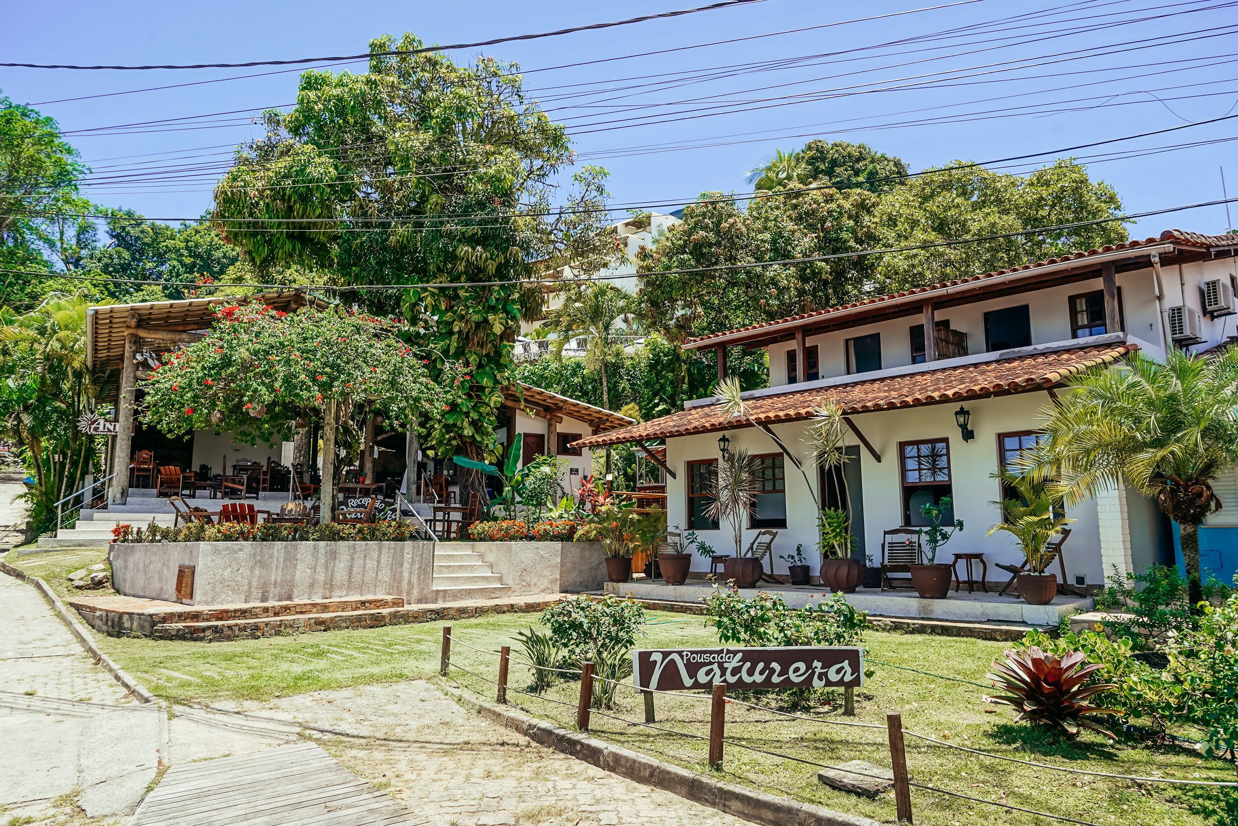 A building with a patio area, outdoor seating, and a sign that reads "Nature."