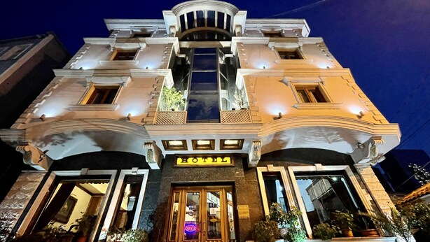 A hotel with a grand entrance, multiple balconies, and a prominent 'HOTEL' sign. - Brilant Antik Hotel (Tirana)