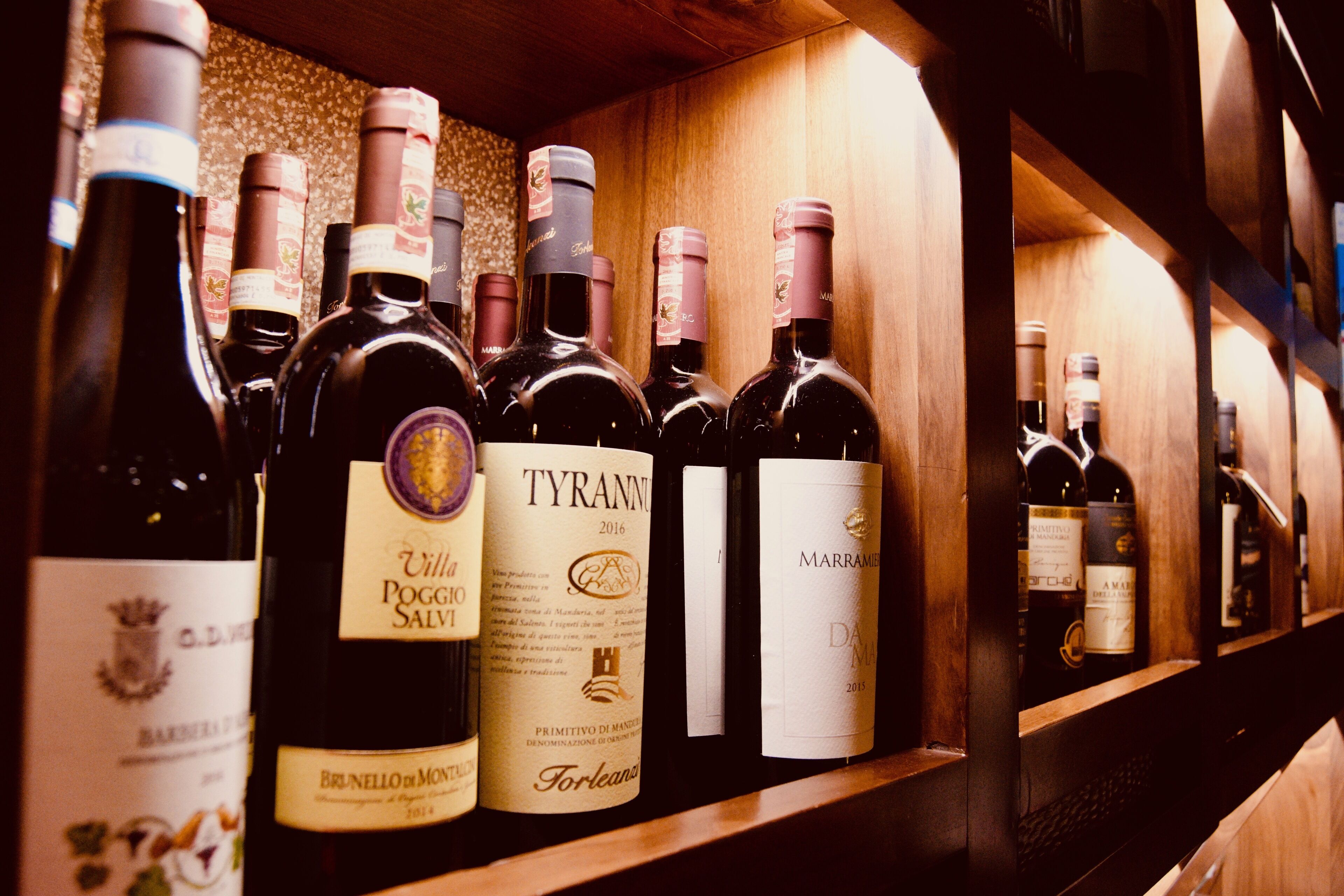 Una botellera de madera con varias botellas de vino.