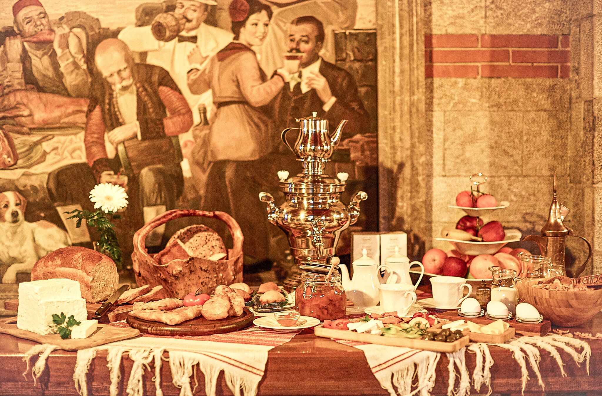 A table set with various food items and a decorative tea set.
