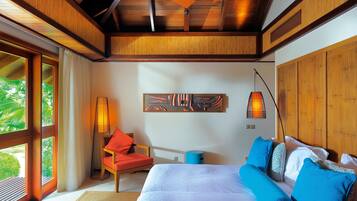 Una habitación de hotel moderna con una cama grande, techo de madera y vistas a zonas verdes.