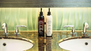 Two sinks with chrome faucets and two bottles of John Masters Organics body wash and hand wash.