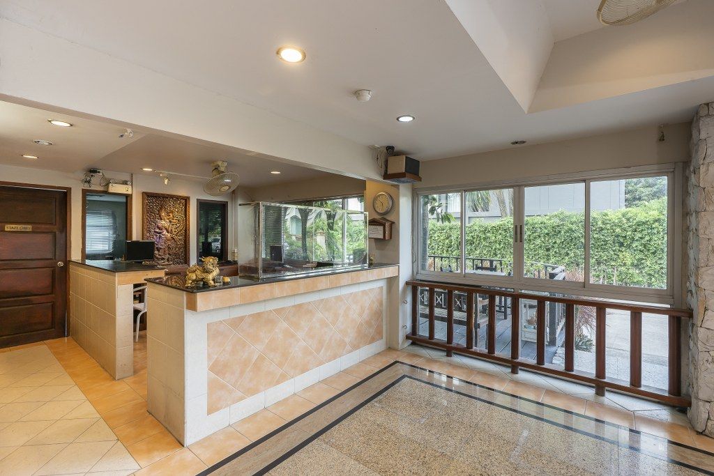 A spacious kitchen with a central island, a dining area with a view, and a large window.