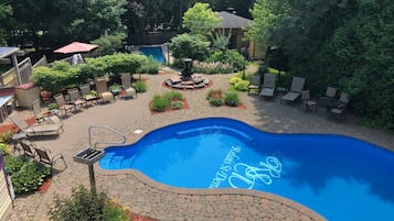 Outdoor pool, a heated pool, open 8:00 AM to 11:00 PM, pool loungers