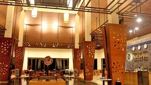 A spacious lobby with high ceilings, wooden paneling, and a reception desk. - The Natsepa Resort & Conference Center (Salahutu)
