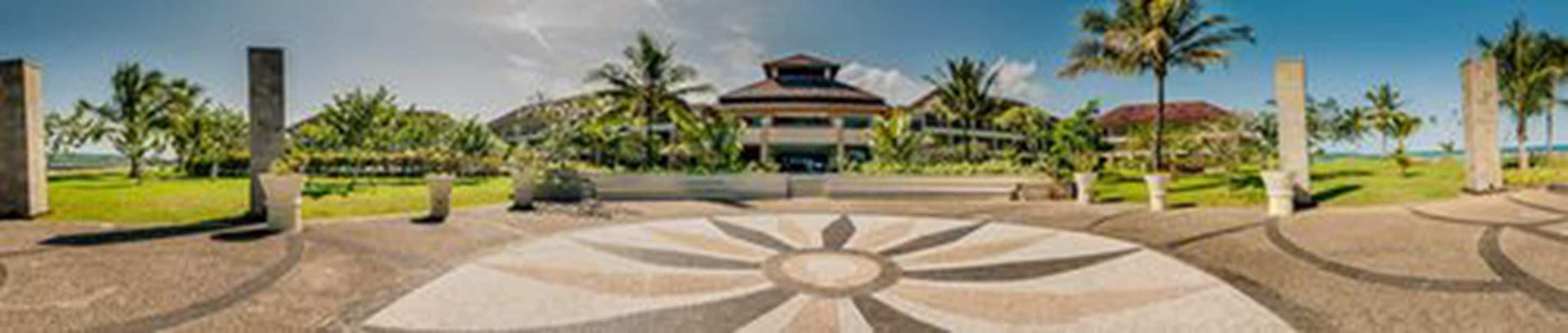 A building with a central dome and a symmetrical garden layout.