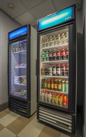 Two beverage vending machines with a variety of drinks and snacks. - Hampton Inn & Suites Bay City, TX (Bay City)
