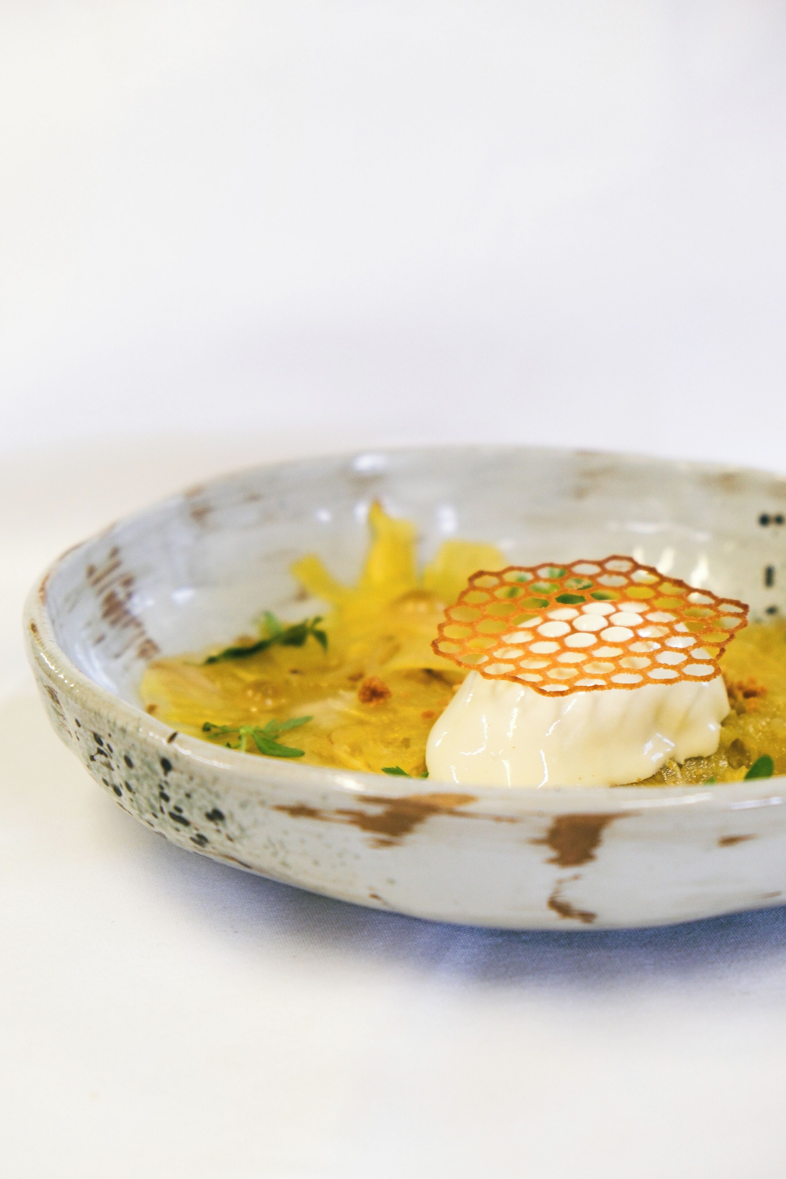 A bowl of soup with a decorative element on top.