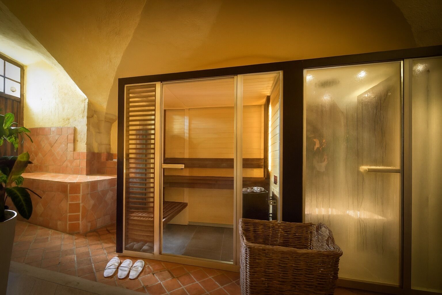 A bathroom with a bathtub, a shower, and a glass door leading to a shower area.