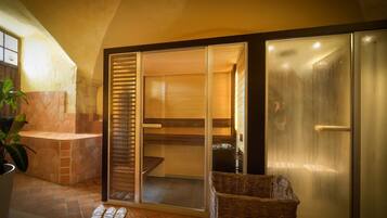 A bathroom with a bathtub, a shower, and a glass door leading to a shower area.
