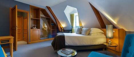 A bedroom with a bed, a desk, a chair, and a wardrobe.