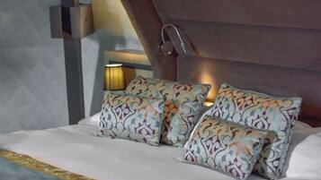 A bed with patterned pillows and a headboard.