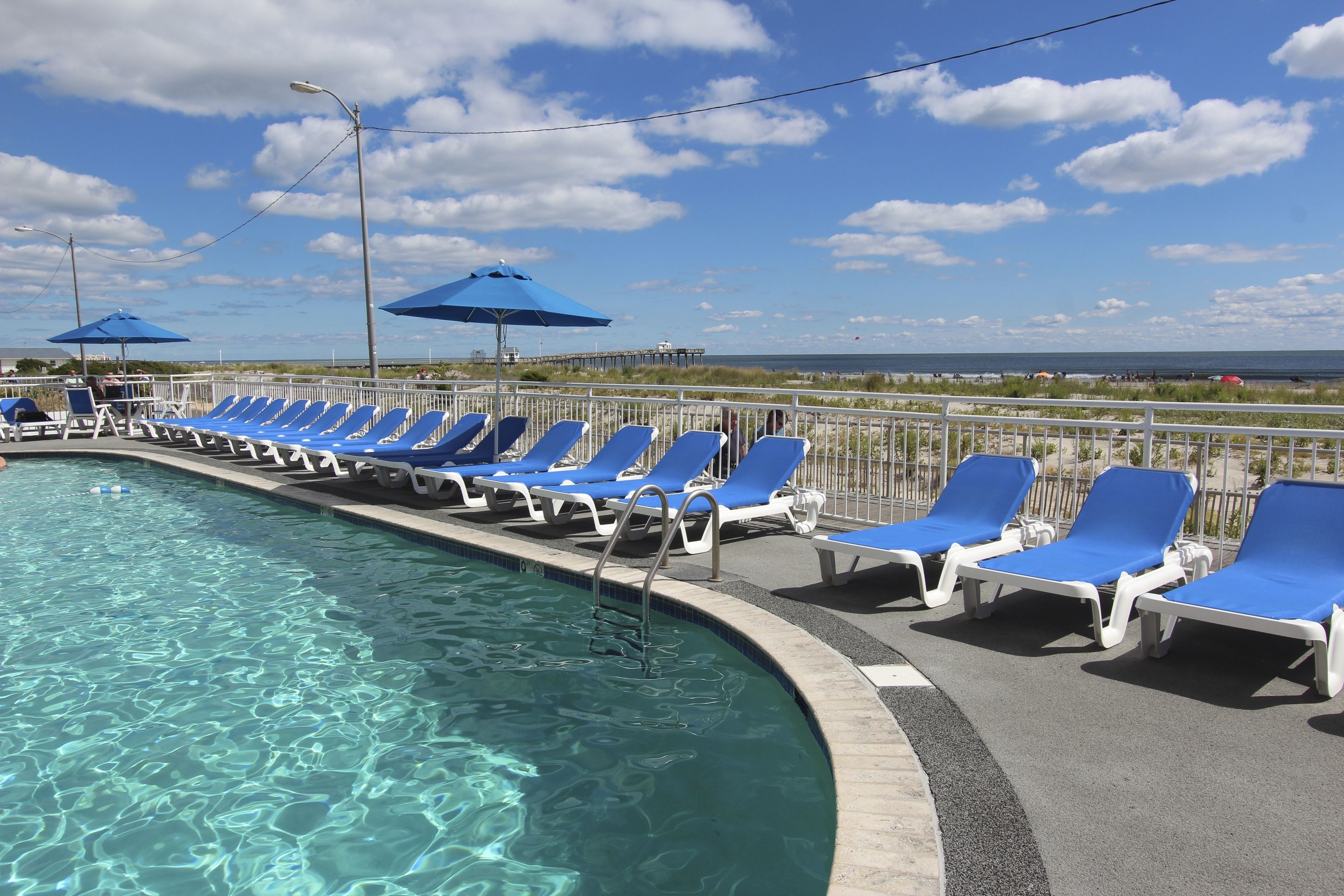seasonal outdoor pool, open 8:00 am to 8:00 pm, pool umbrellas