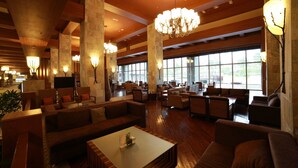 A spacious lobby with high ceilings, large windows, and modern lighting fixtures.