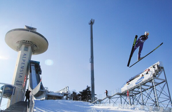 A ski jump ramp with a Samsung advertisement and a tall tower labeled "ALPENSIA" in the background. - InterContinental Pyeongchang Resort Alpensia by IHG (Pyeongchang)
