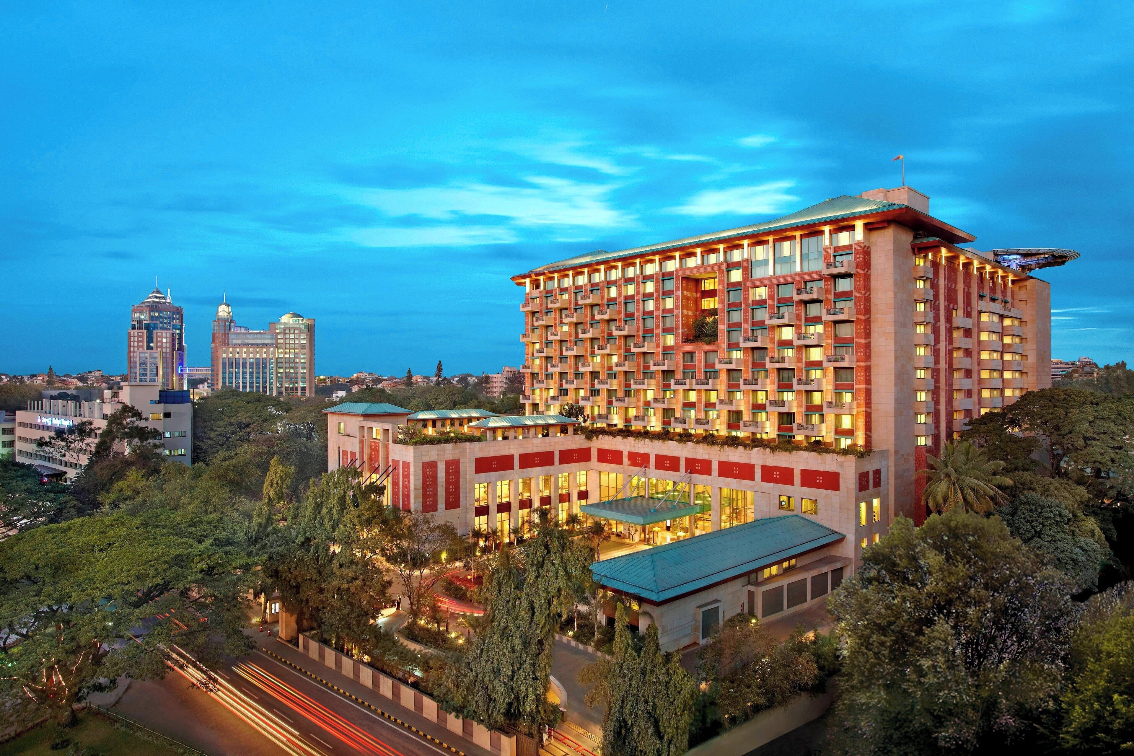 A multi-story hotel with a modern design, featuring a rooftop terrace and a landscaped courtyard.