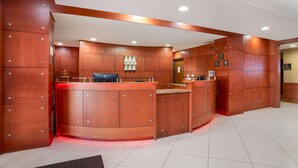 A reception area with a curved desk, multiple lockers, and a small seating area. - Best Western Plus Flowood Inn & Suites (Flowood)