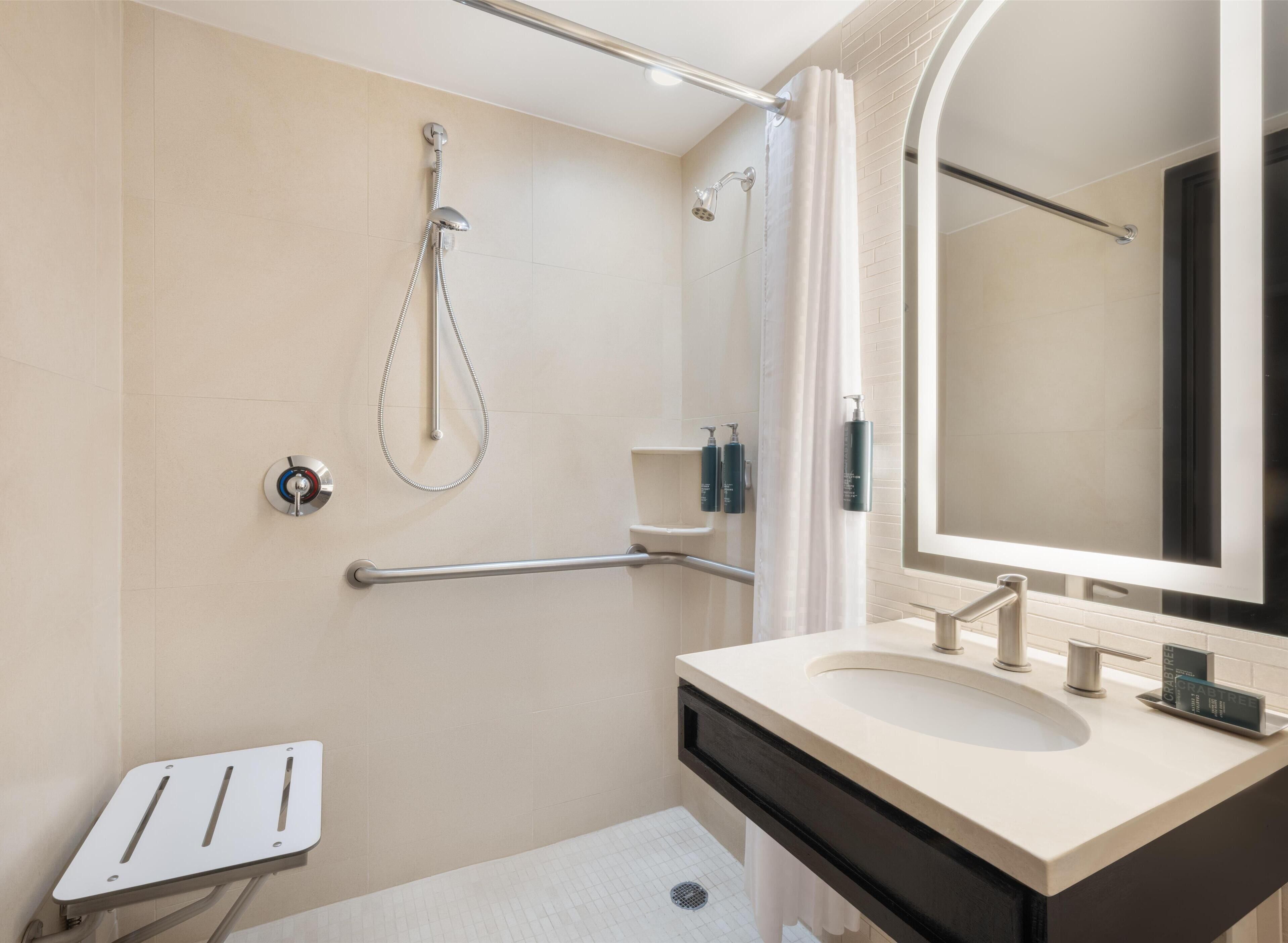 one queen bed, roll in shower | bathroom shower