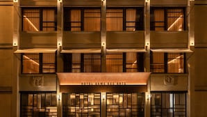 A hotel facade with a central entrance, multiple balconies, and a sign reading "HOTEL DAME DES ARTS". - Hotel Dame des Arts (Paris)