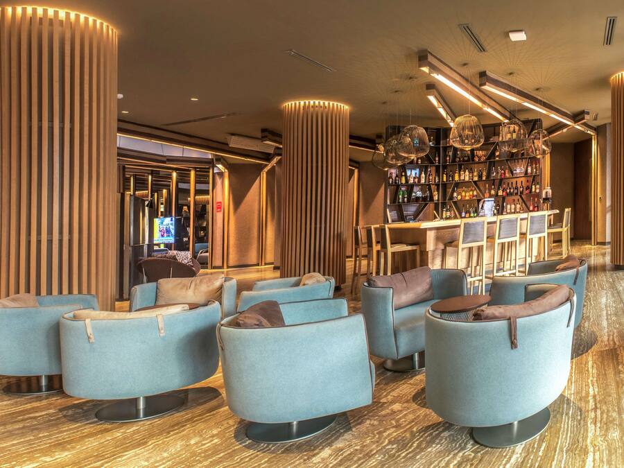 A modern lounge area with seating and a bar.