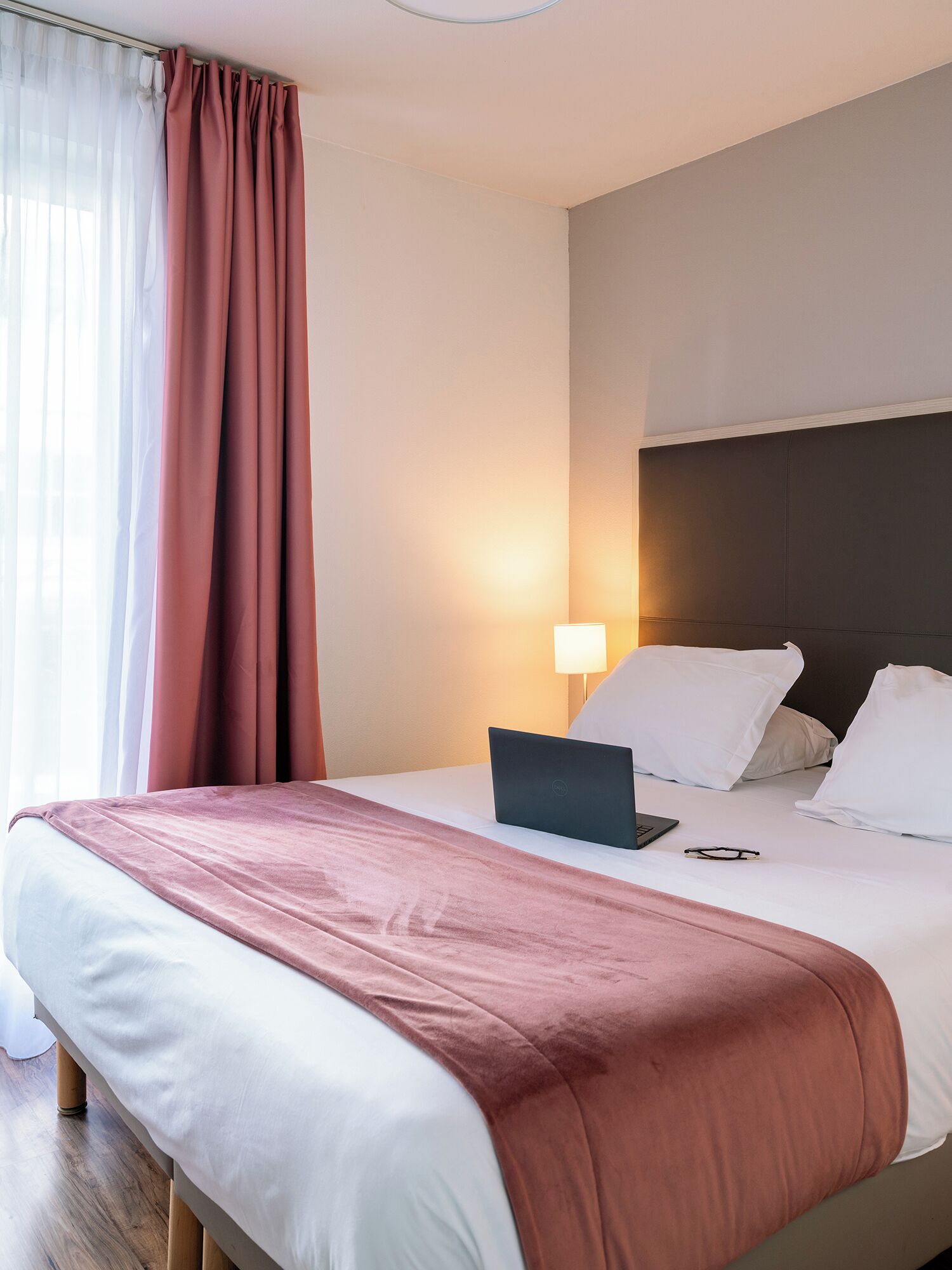 Studio | Desk, laptop workspace, blackout drapes, iron/ironing board