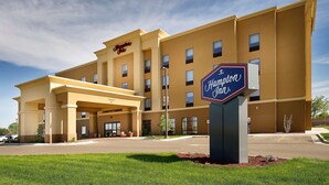 Un hôtel Hampton Inn au design moderne, doté d’une grande entrée et d’une enseigne.
