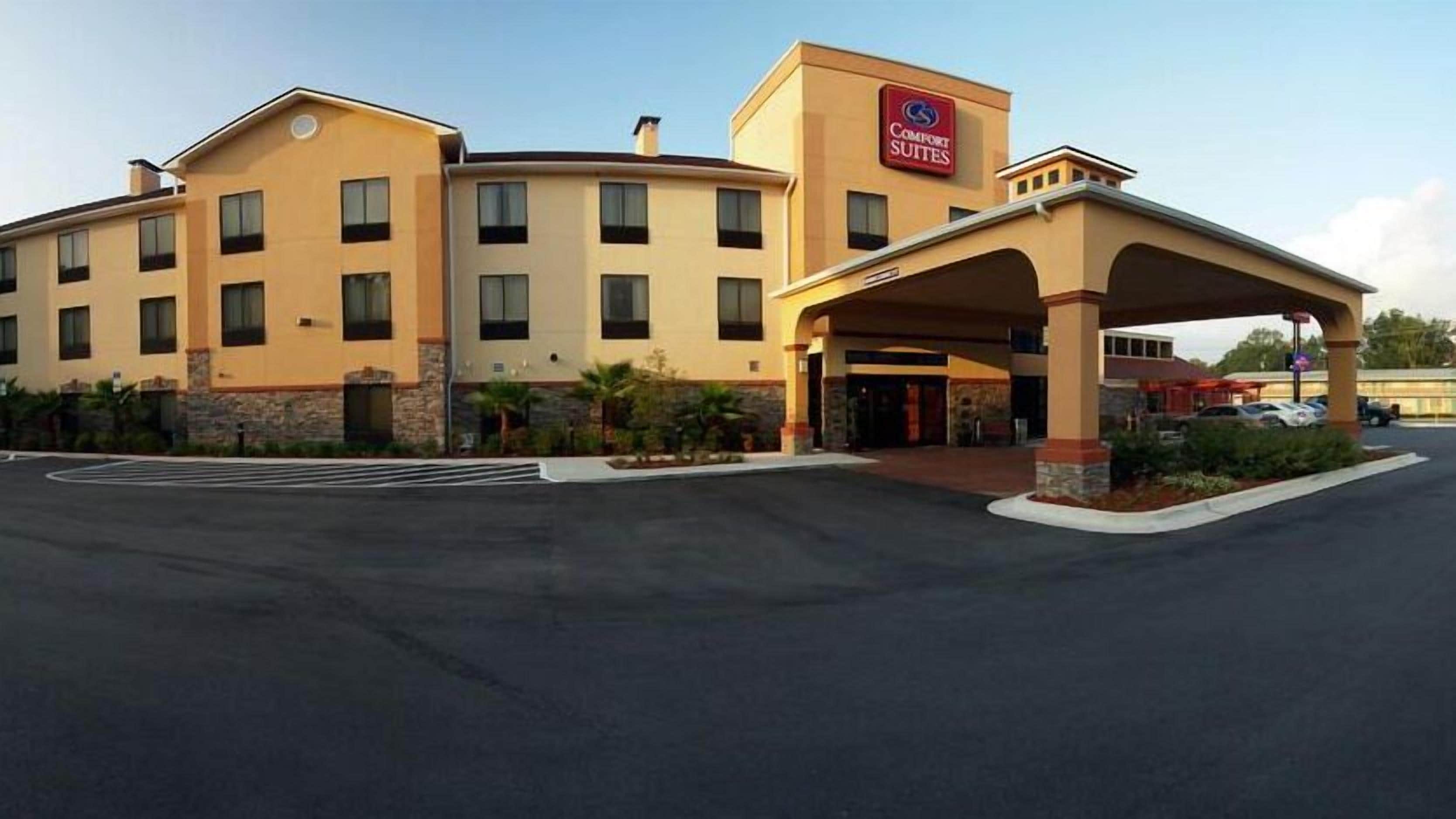 A Comfort Suites hotel with a covered entrance and a parking lot.