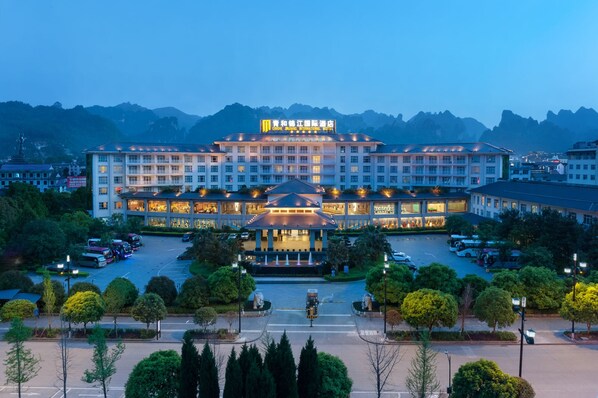 A large hotel with multiple floors and a central courtyard. - Qinghe Jin Jiang International Hotel (Zhangjiajie)