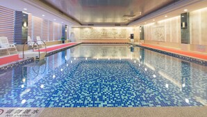 An indoor swimming pool with a tiled floor and walls, a red carpet, and a no diving sign. - Qinghe Jin Jiang International Hotel (Zhangjiajie)