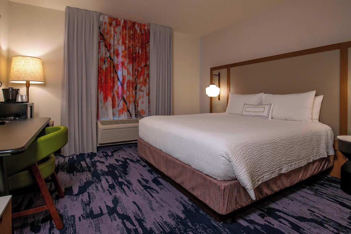 Hypo-allergenic bedding, desk, laptop workspace, blackout curtains