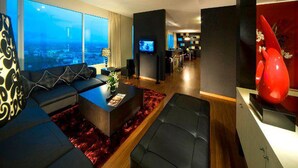 A modern living room with a large window, a television, and a red sculpture. - Pullman Kuching (Kuching)