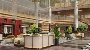 A spacious lobby with a central seating area, multiple floors, and a staircase. - Pullman Kuching (Kuching)